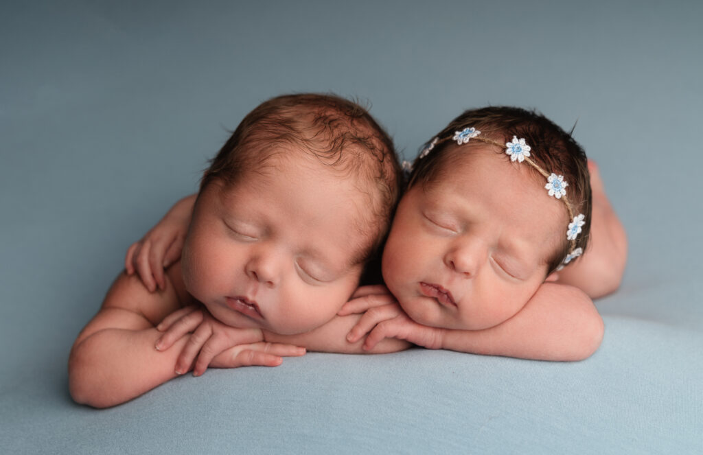 twin newborn babies on blue